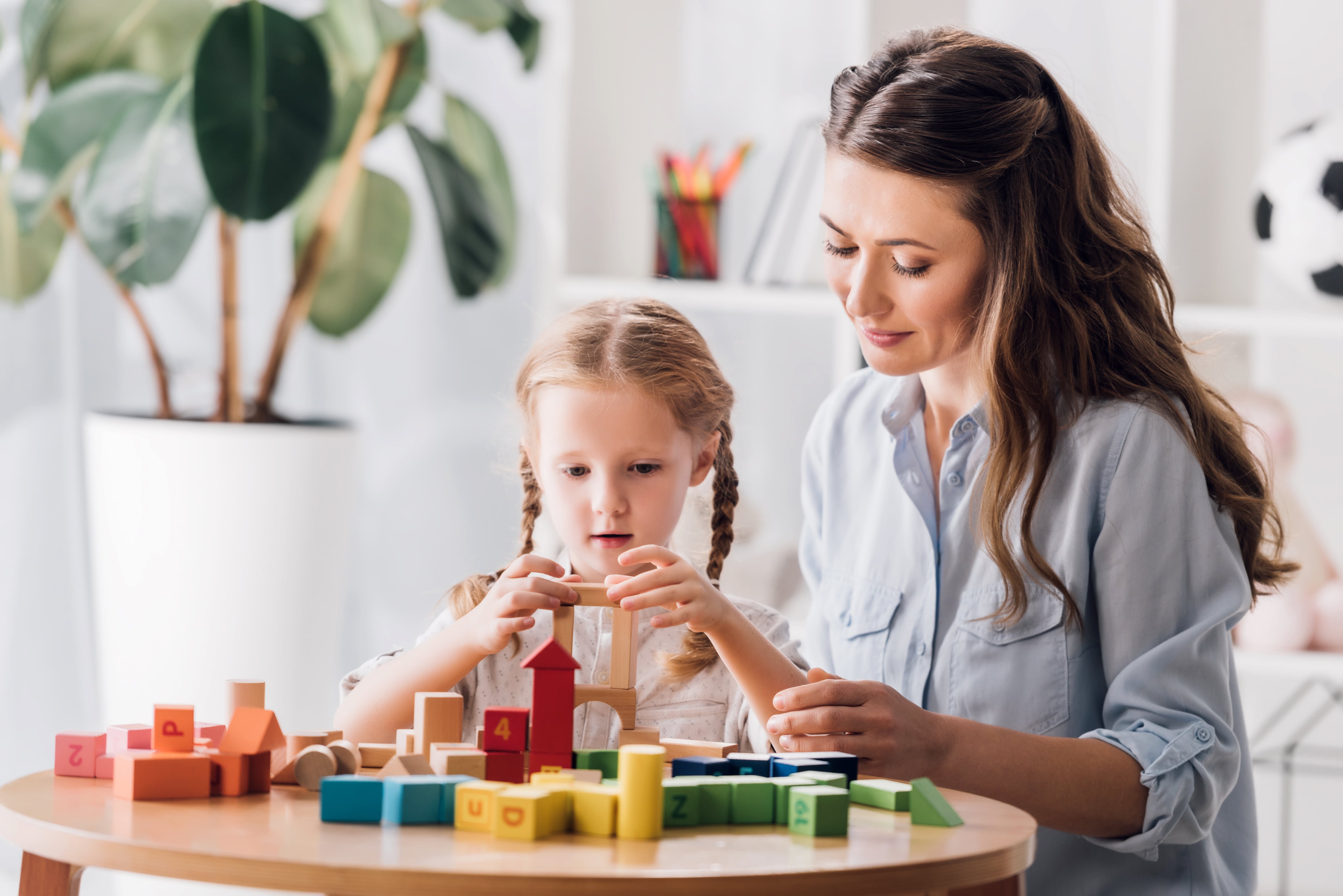 Psychologist playing blocks with child